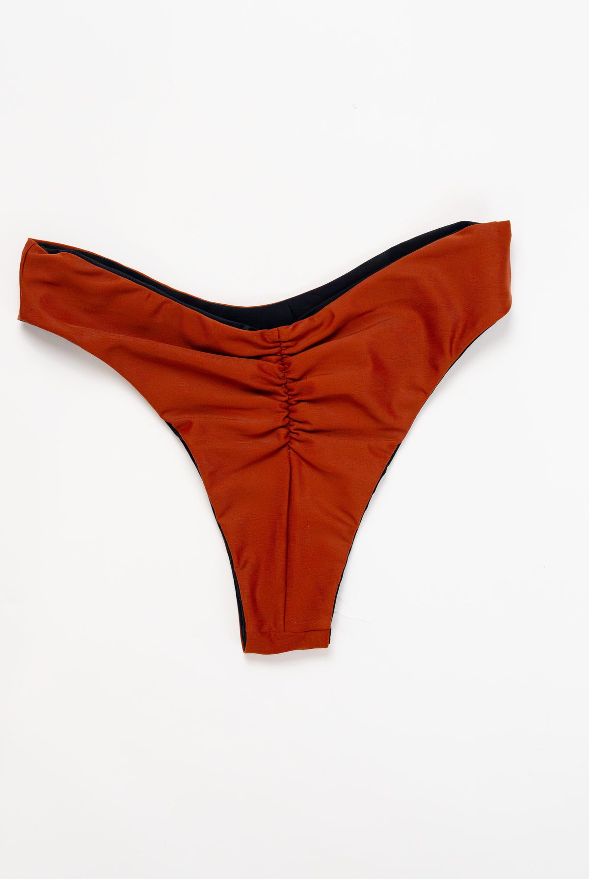 Flat lay of the Duo reversible bikini bottom in Sand showing the ruched back