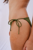 Side view of the adjustable ties on the Palermo bikini bottom